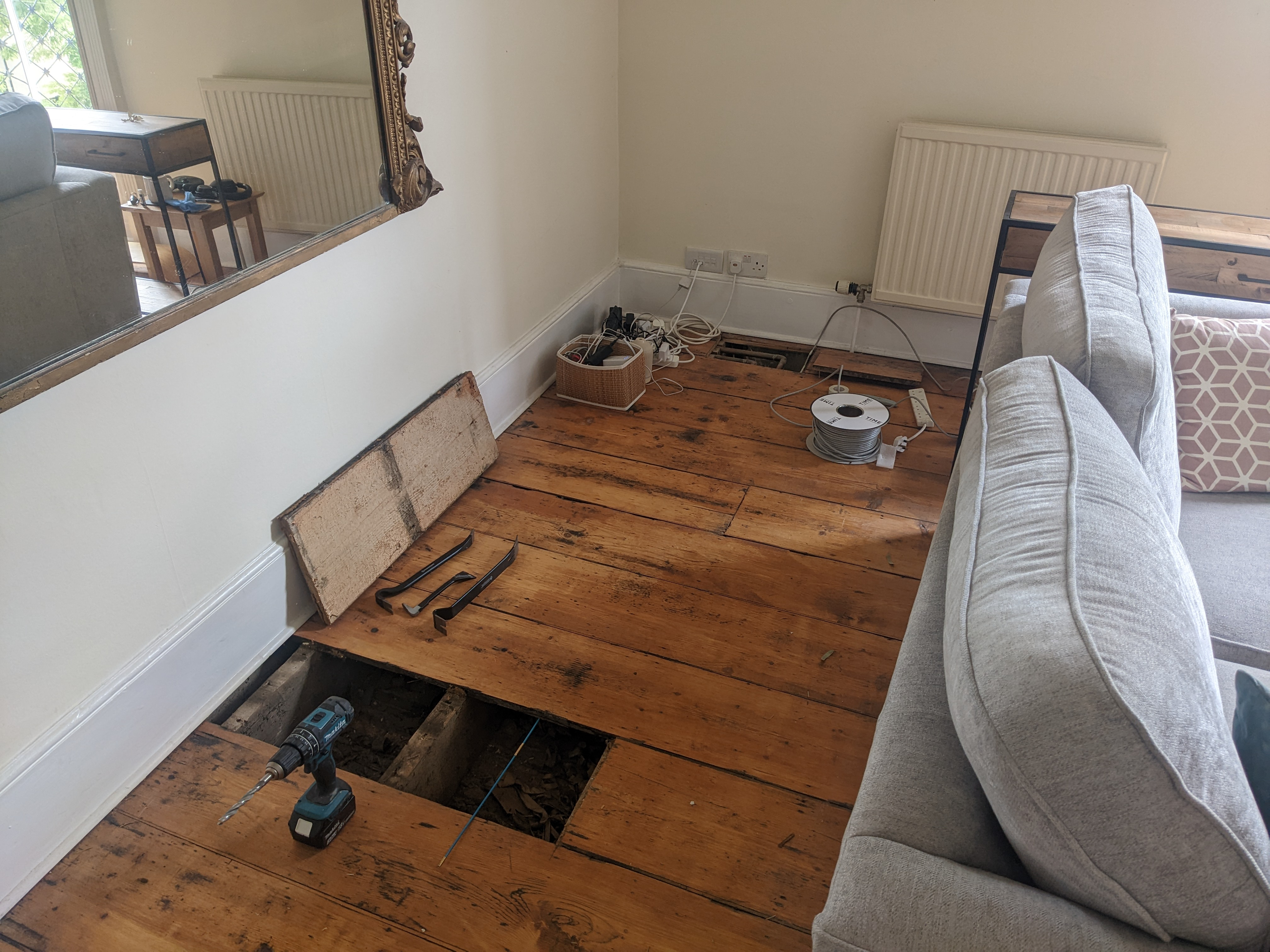 Getting the floorboards up (crowbar seeing a lot of use)